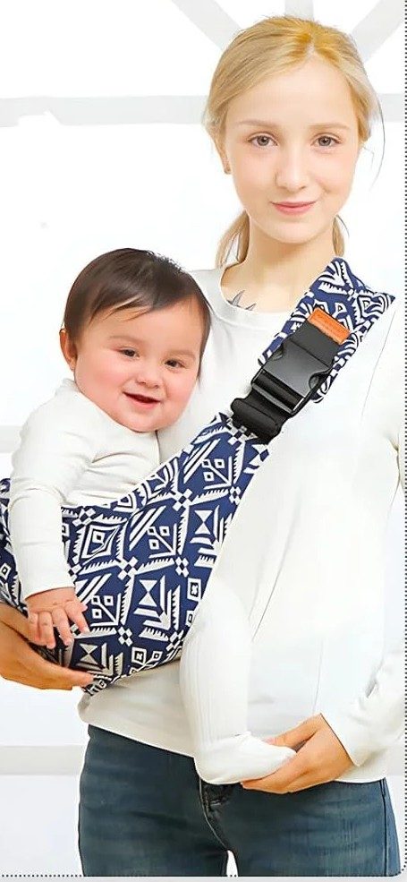 Baby carried on the hip in the shoulder carrier