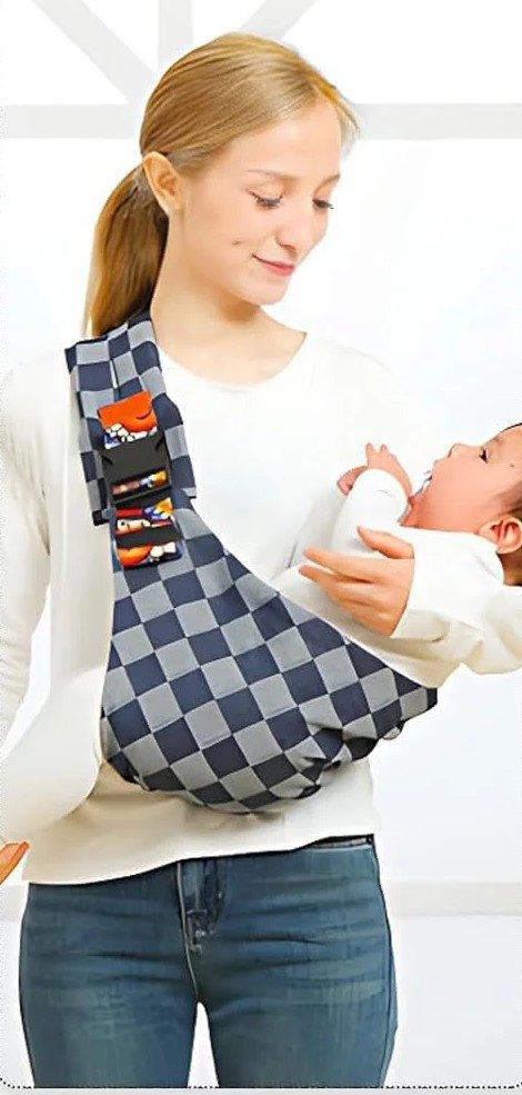 Newborn lying close against the chest in the shoulder carrier