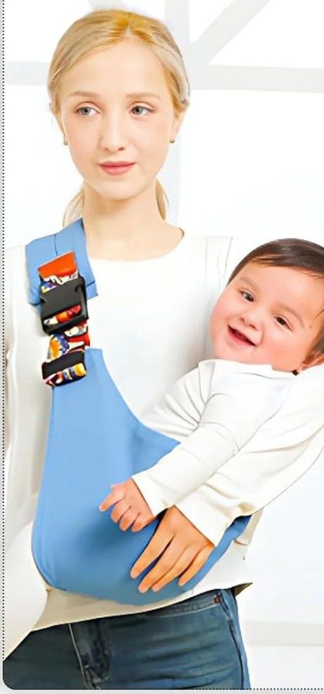 Baby carried diagonally across the chest in the shoulder carrier